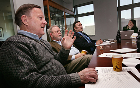 Judges Rex Stucky, Jim Wallace and John Metelsky discuss the merits of the photgraphy submissions. Photo by Sgt. Michael S. Cifuentes