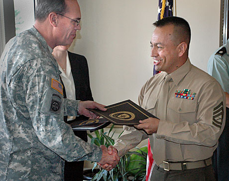 CC, GySgt. Sergio Jimenez, is congratulated by DINFOS Commandant, Army Col. Gary Keck, during graduation ceremonies for the Joint Senior Enlisted Public Affairs Course held last month.  (Photo by LtCol. Frank Urben, USAF retired)